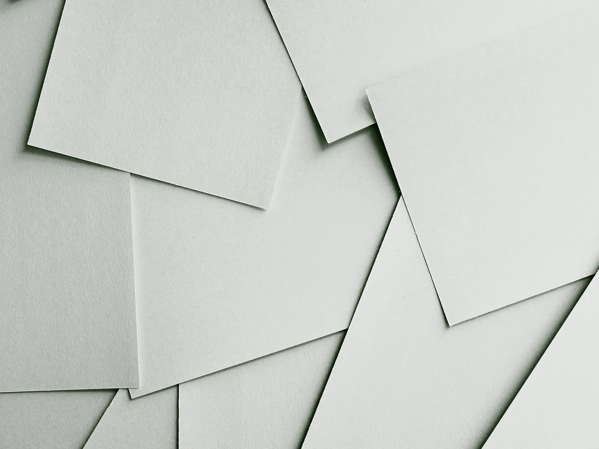 Blank white sheets of paper overlapping on a flat surface
